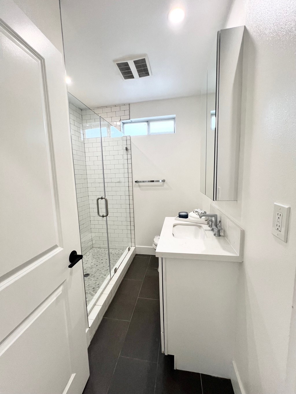 a small bathroom with a sink and a shower