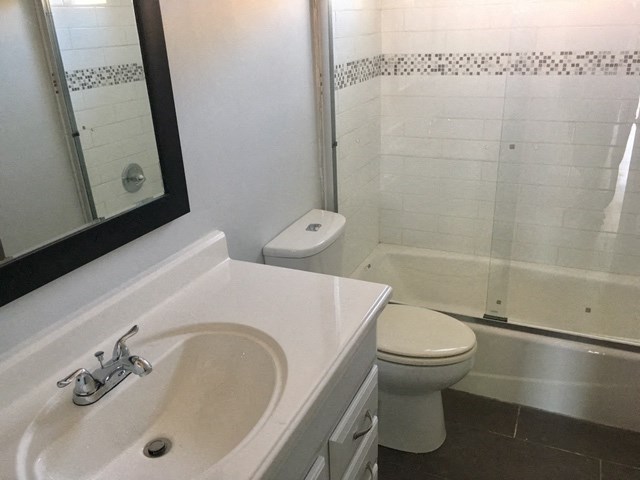 a bathroom with a sink and a toilet and a shower
