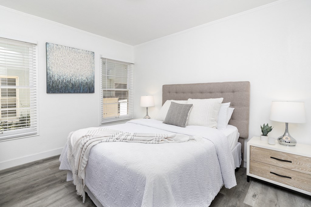 a bedroom with a large bed and a window