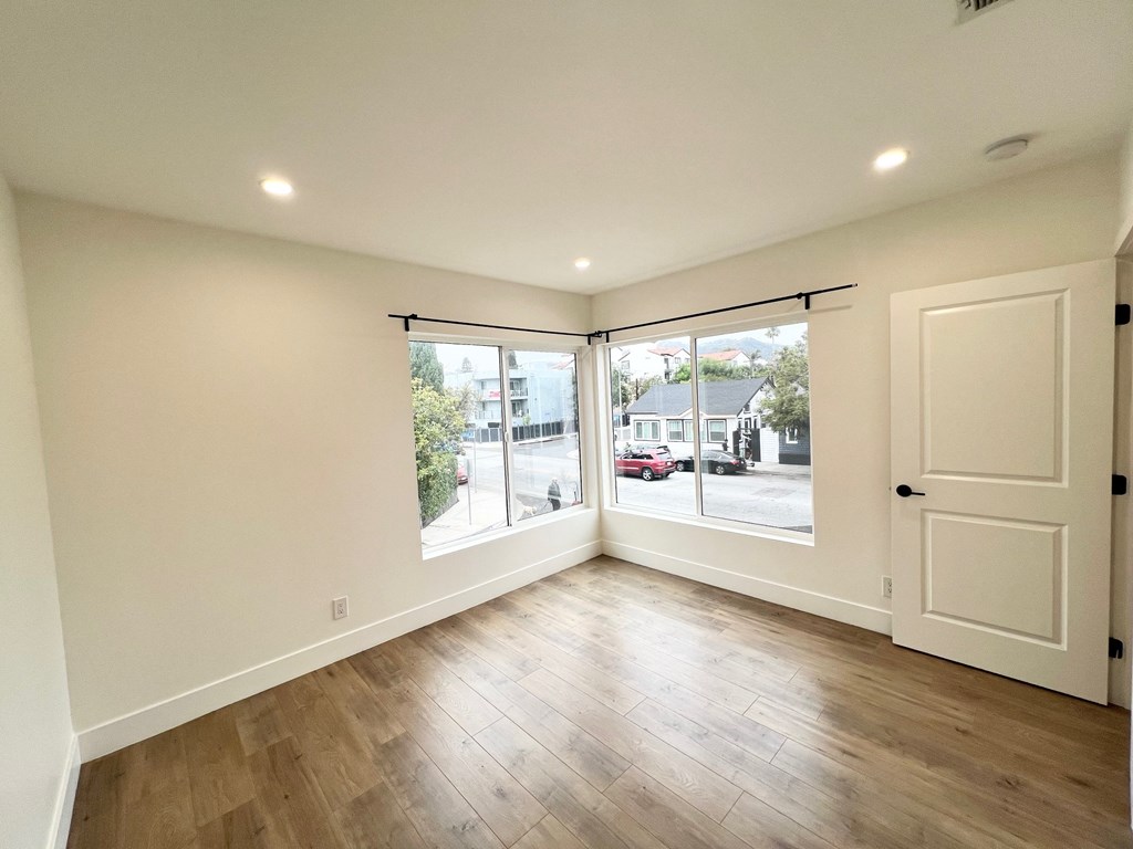 a living room with a large window and a door to a street