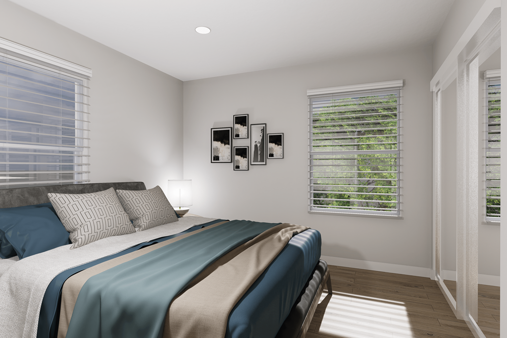 a bedroom with a bed and two windows