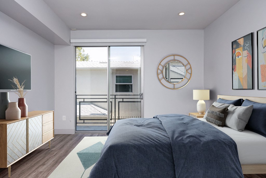 a bedroom with a bed and a sliding glass door