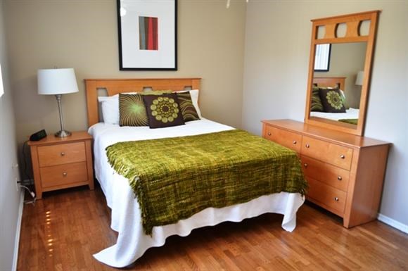 a bedroom with a bed and a mirror