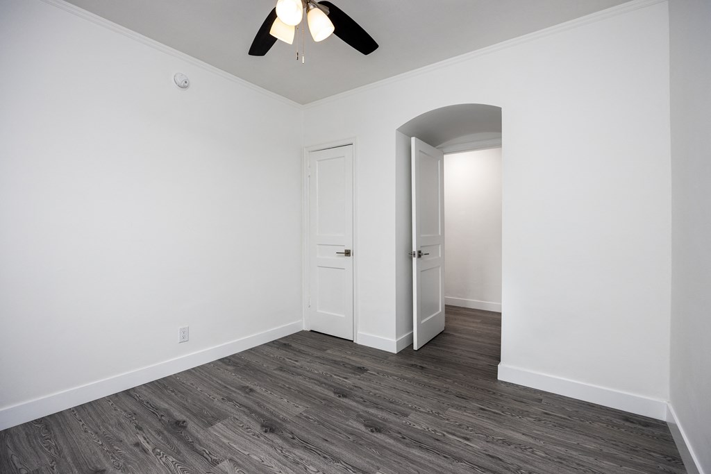a bedroom in an empty house with a ceiling fan