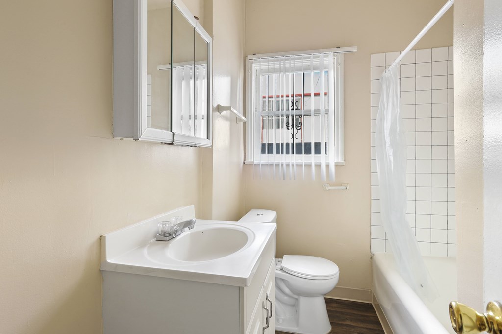 A white sink and toilet in a bathroom.