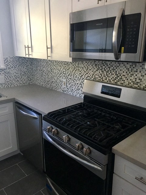 a kitchen with a stove and a microwave