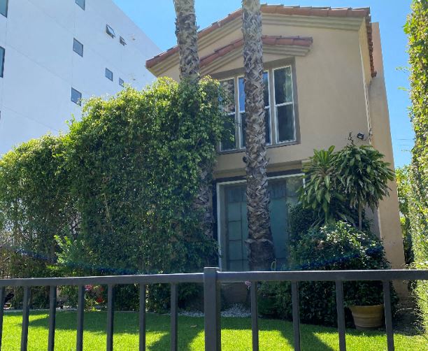 a house with a fence in front of it