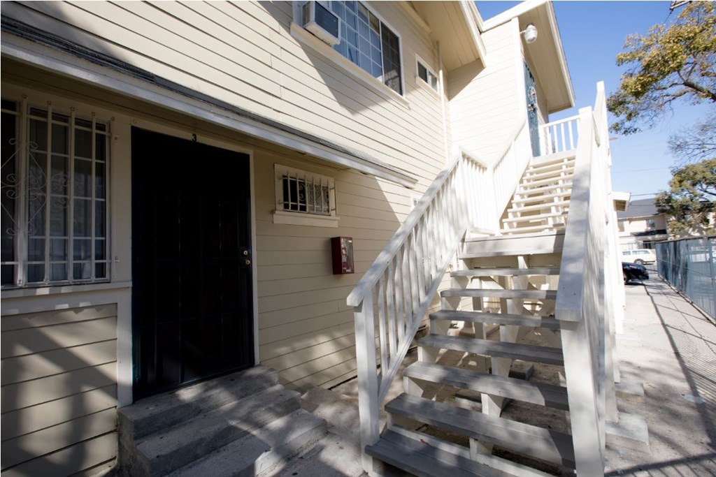 A house with a staircase leading to the front door.
