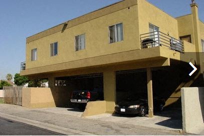 a building with two cars parked under it