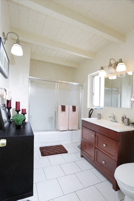 a bathroom with a sink and a toilet and a shower