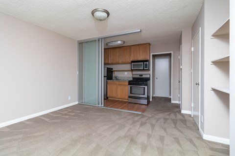 A kitchen with a white ceiling and a white door.