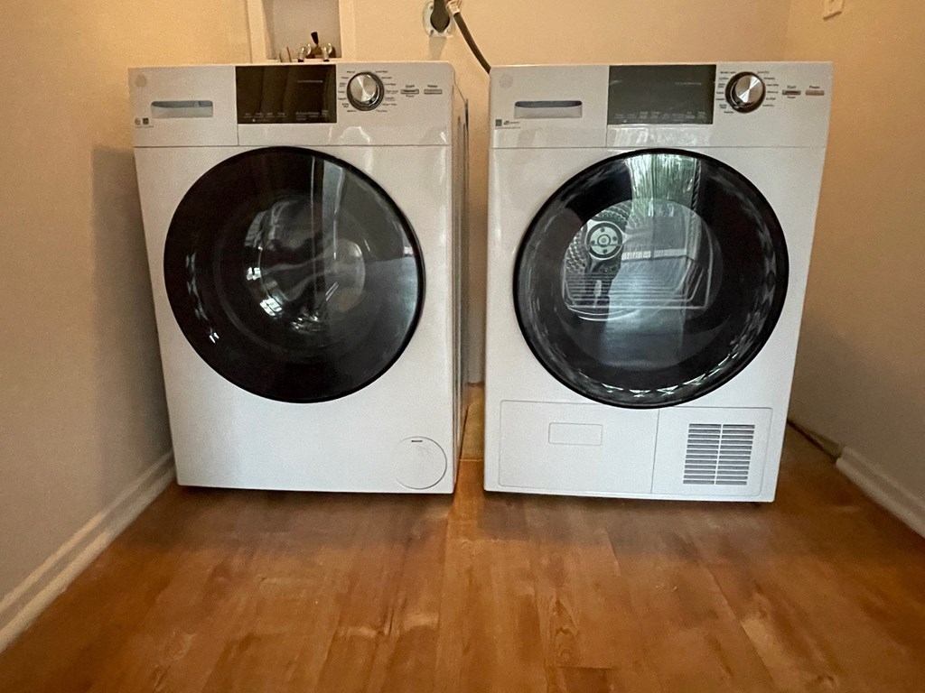 two washing machines sitting next to each other in a room