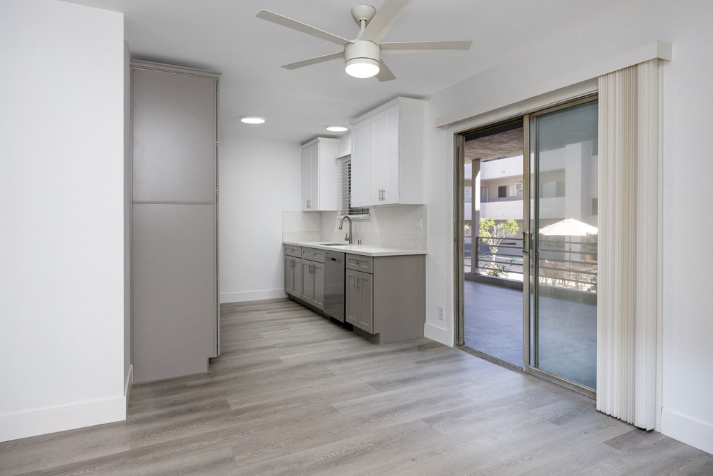 an empty kitchen with a sliding glass door to a patio