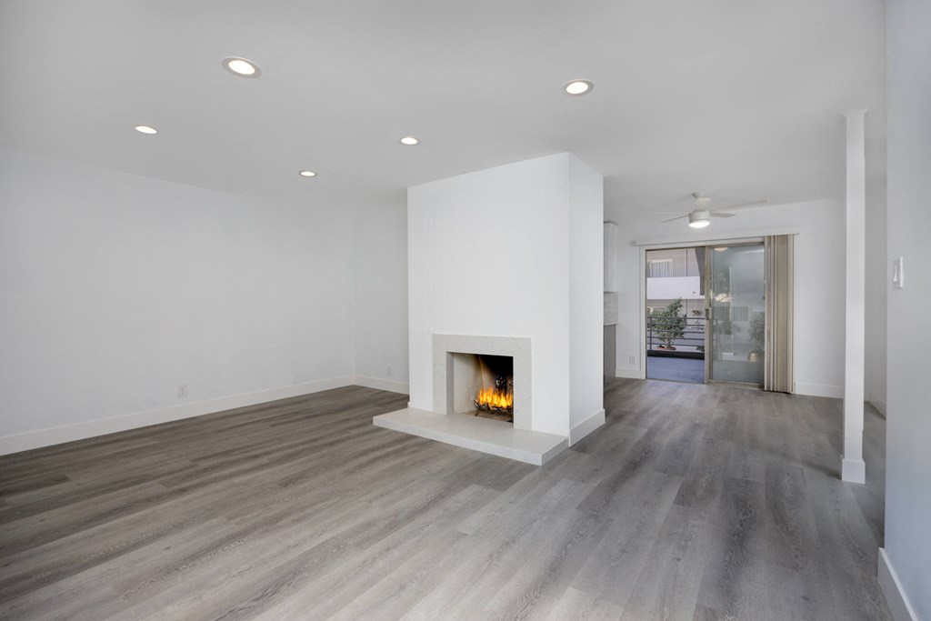a living room with white walls and a fireplace