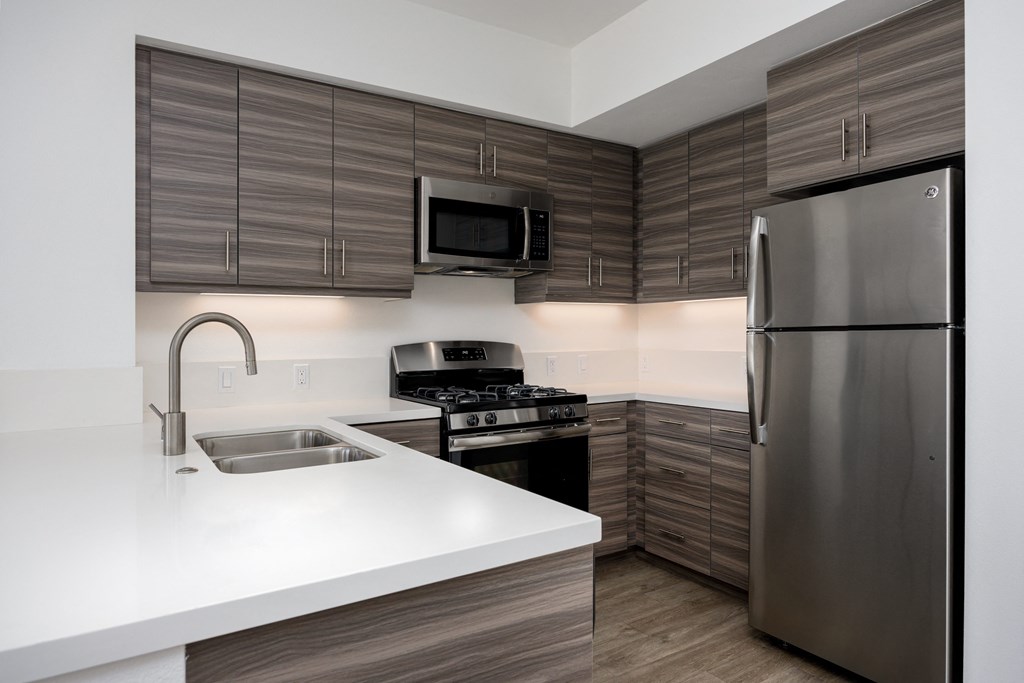 a kitchen with stainless steel appliances and a white counter top