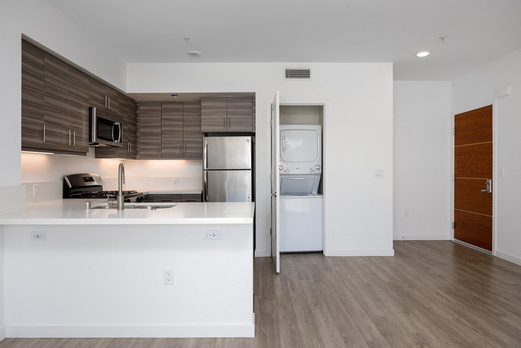 a kitchen with a sink refrigerator and a washer and dryer