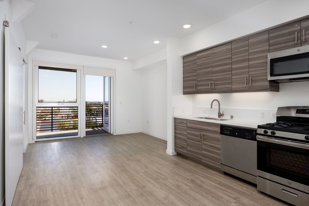 a kitchen with stainless steel appliances and wooden cabinets