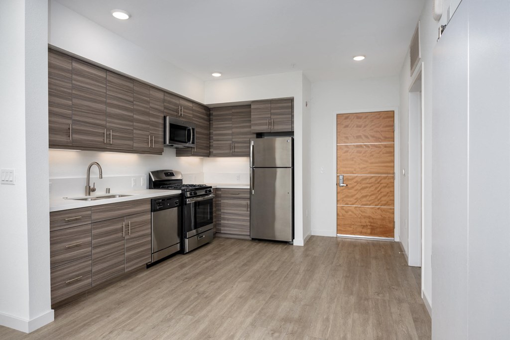 a kitchen with stainless steel appliances and wooden cabinets