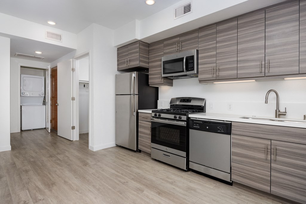 a kitchen with stainless steel appliances and a refrigerator