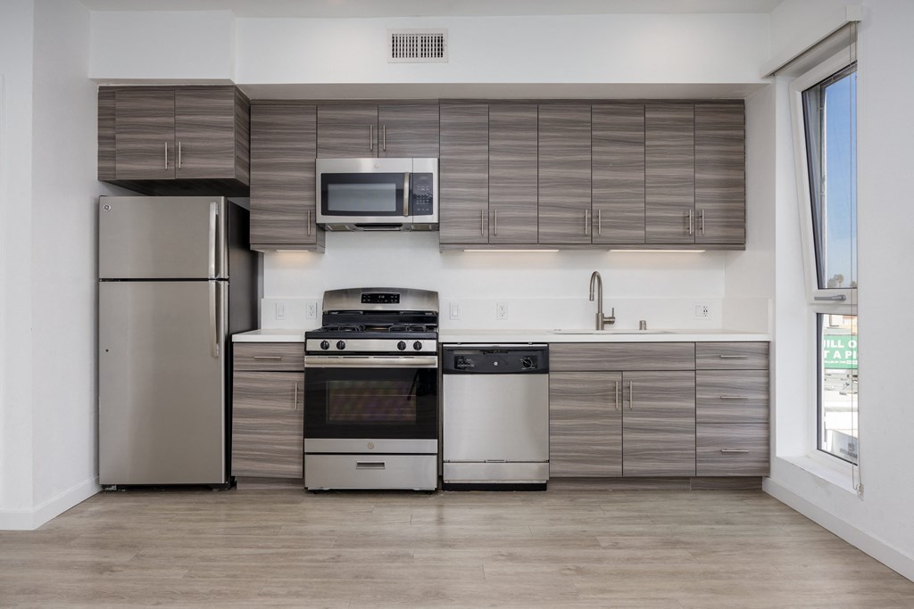 a kitchen with stainless steel appliances and wooden cabinets