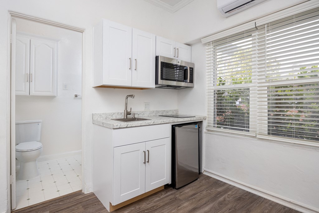 a kitchen with a sink and a microwave and a window