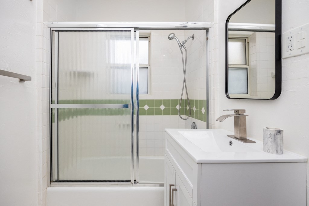 a small bathroom with a shower and a sink