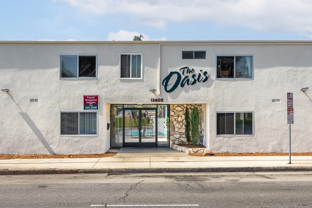 the oasis building on the corner of a street