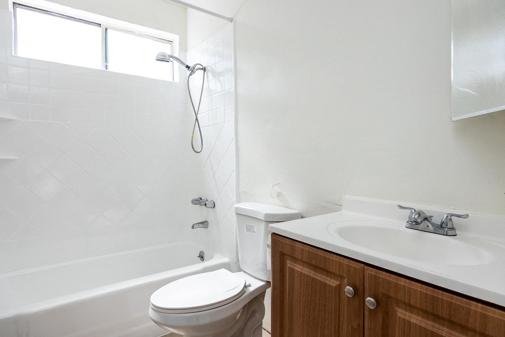 an empty bathroom with a sink toilet and shower