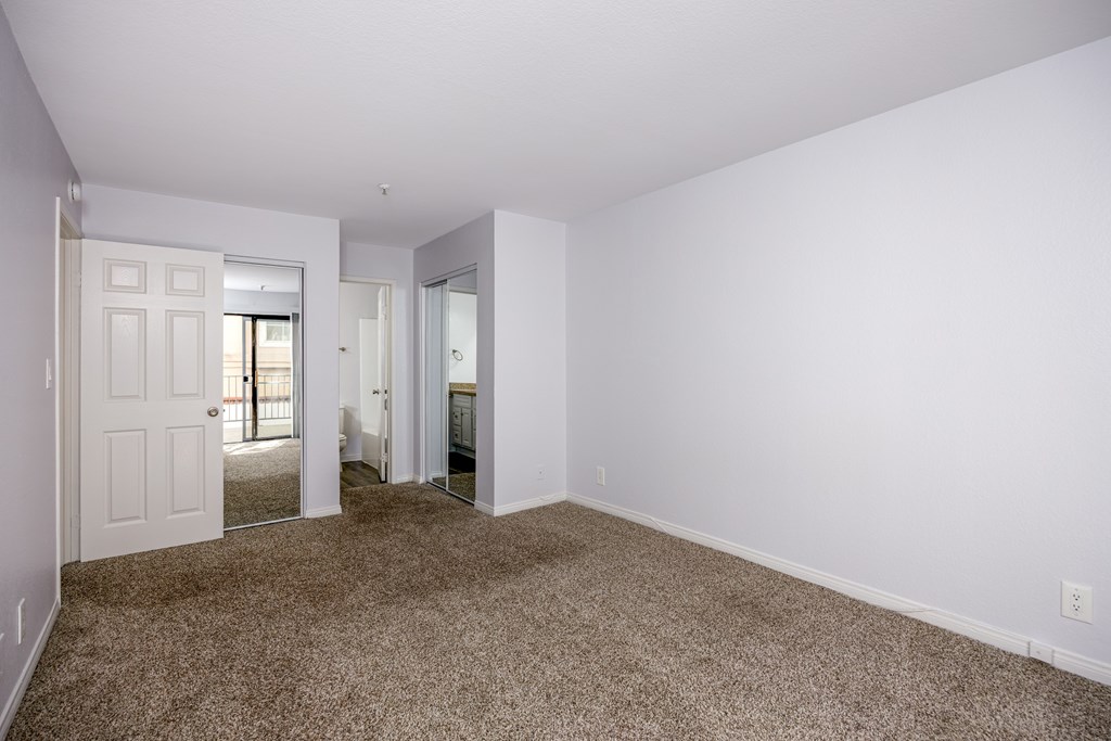 A room with white walls and carpeted floor.