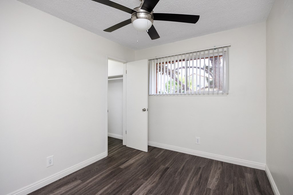 an open living room with a ceiling fan and a window