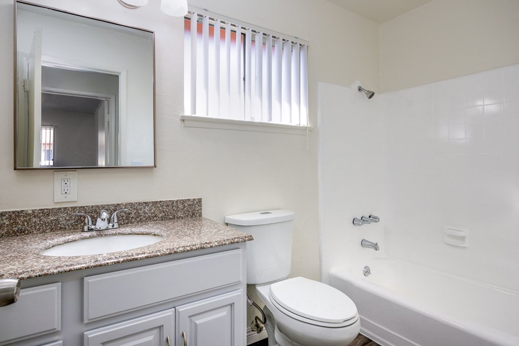 a bathroom with a sink toilet and a bath tub