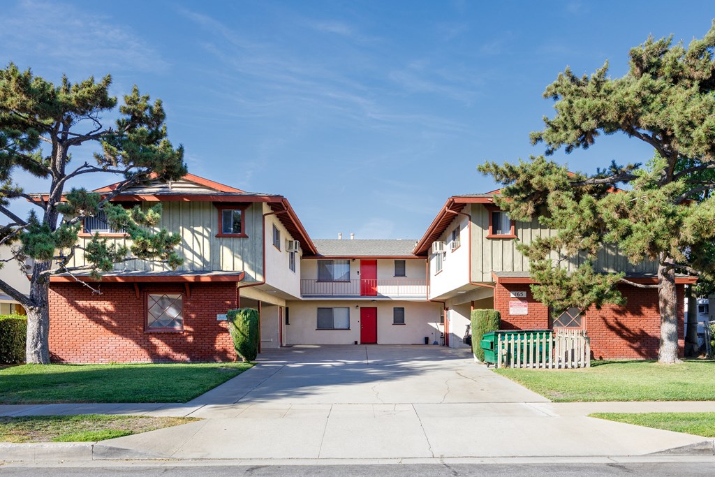 a street view of an apartment building with a driveway