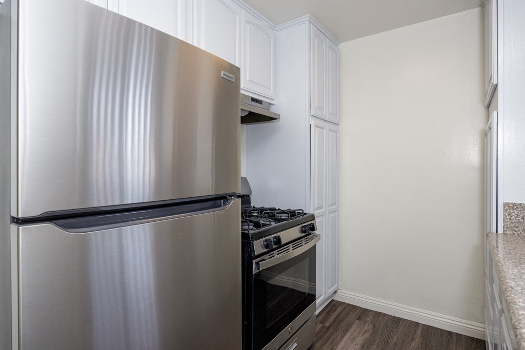a kitchen with stainless steel appliances and a refrigerator