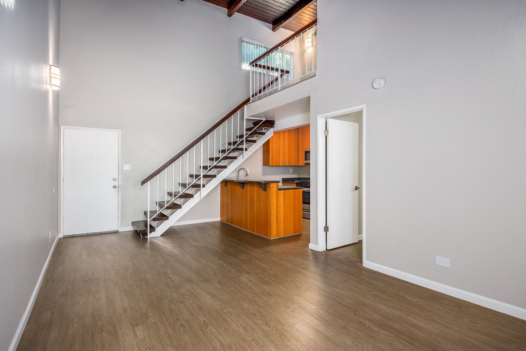 A room with a staircase and a white door.