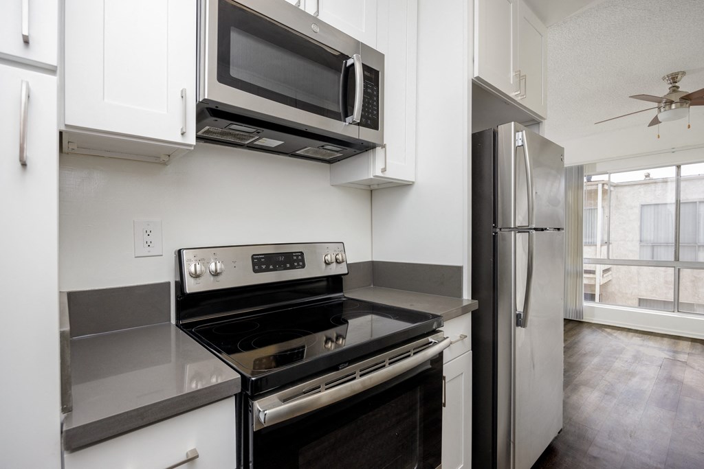 a kitchen with stainless steel appliances and a microwave