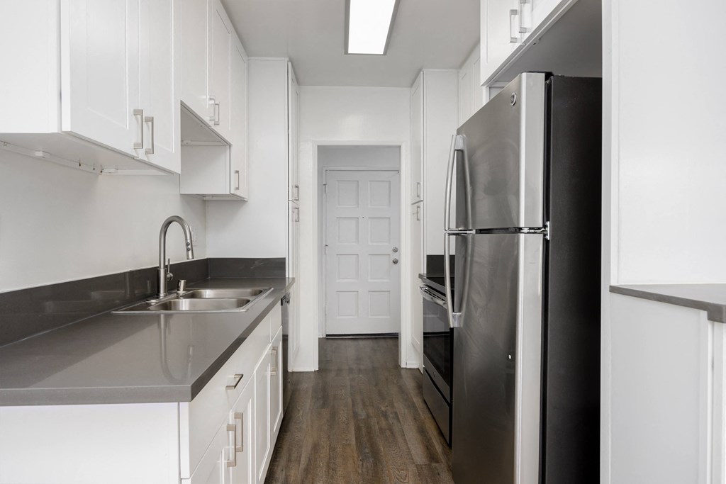a kitchen with stainless steel appliances and white cabinets