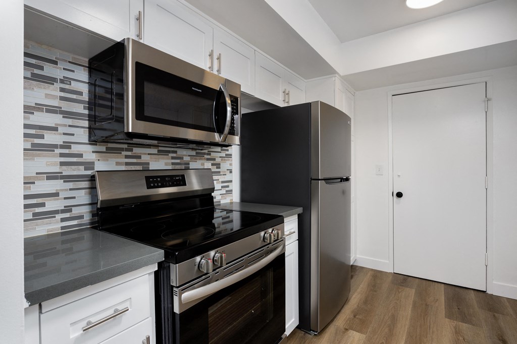 a kitchen with stainless steel appliances and a refrigerator