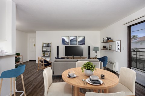 A modern dining room with a wooden table and chairs.