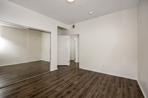 A room with a wooden floor and white walls.