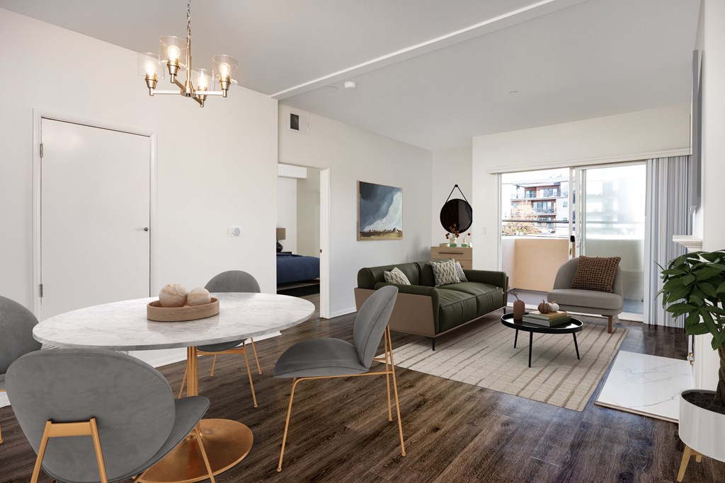 A modern living room with a white table and grey chairs.