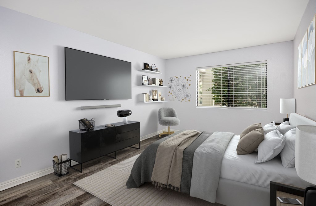 A modern bedroom with a large bed and a flat screen TV mounted on the wall.