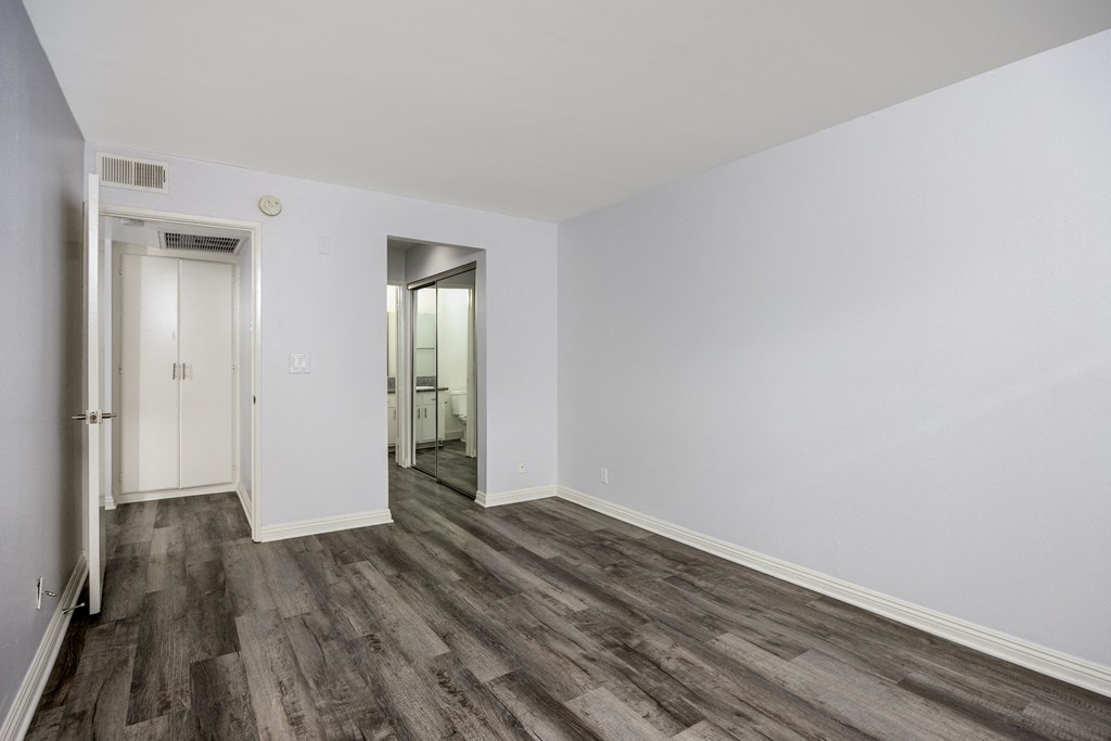 A room with a wooden floor and white walls.