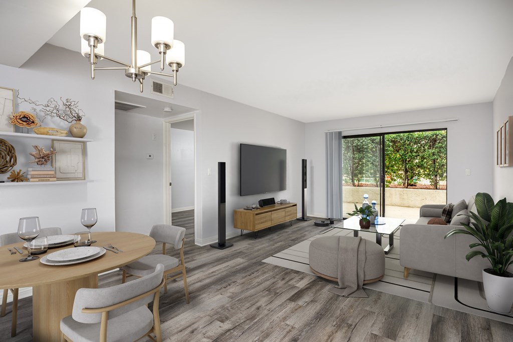 A modern living room with a dining table set for two.