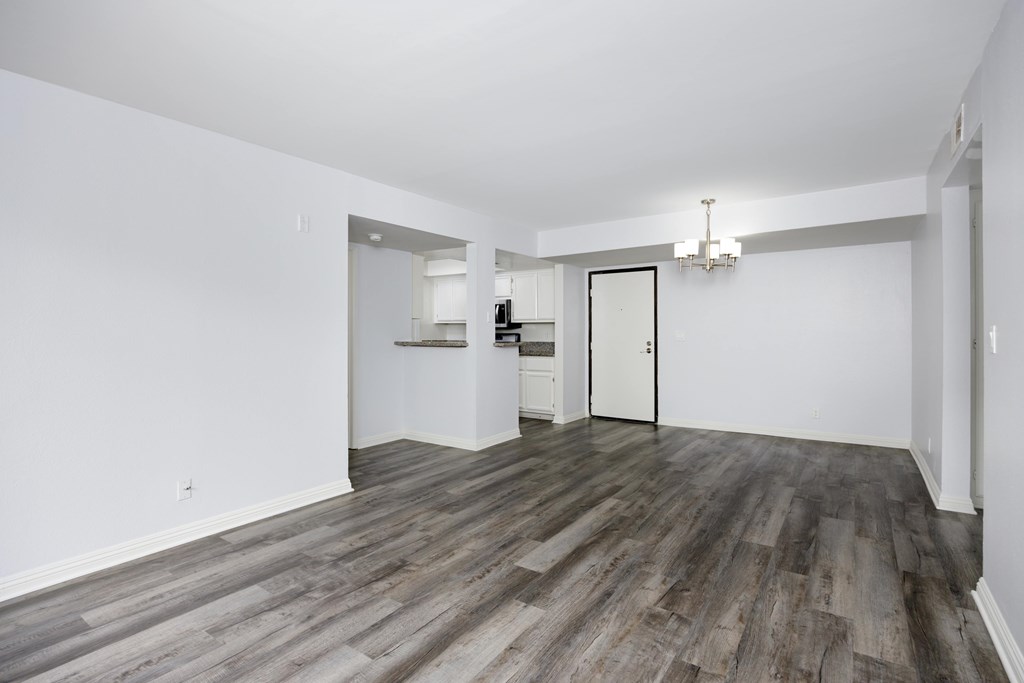 A room with a wooden floor and white walls.