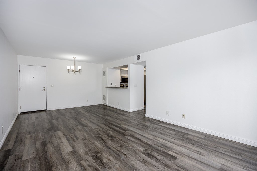 A room with a chandelier and a cabinet.
