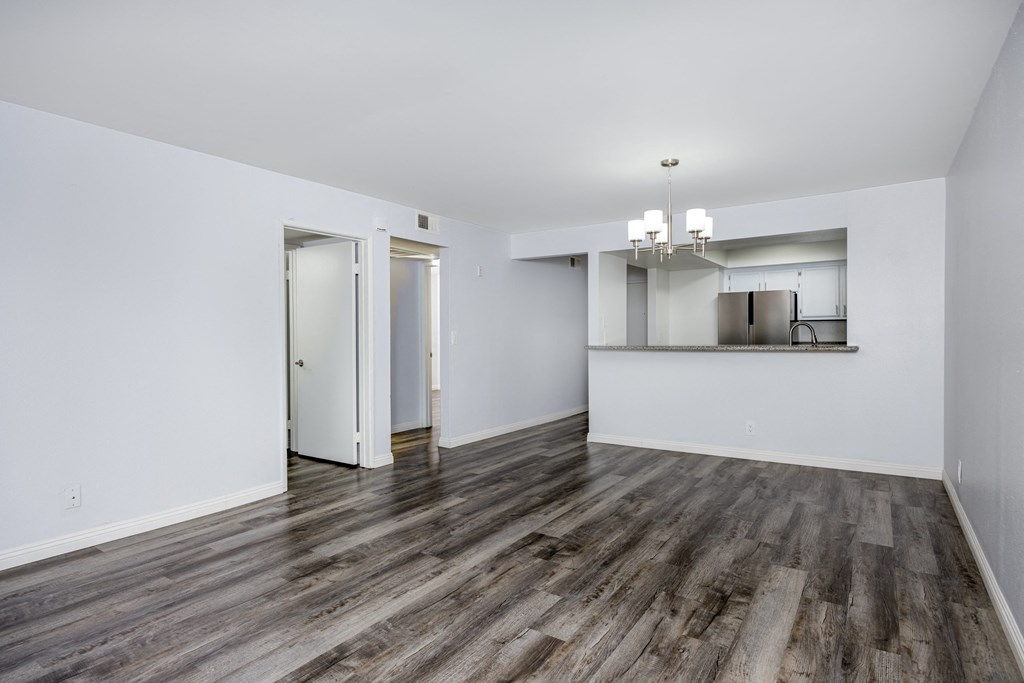 A room with a wooden floor and white walls.