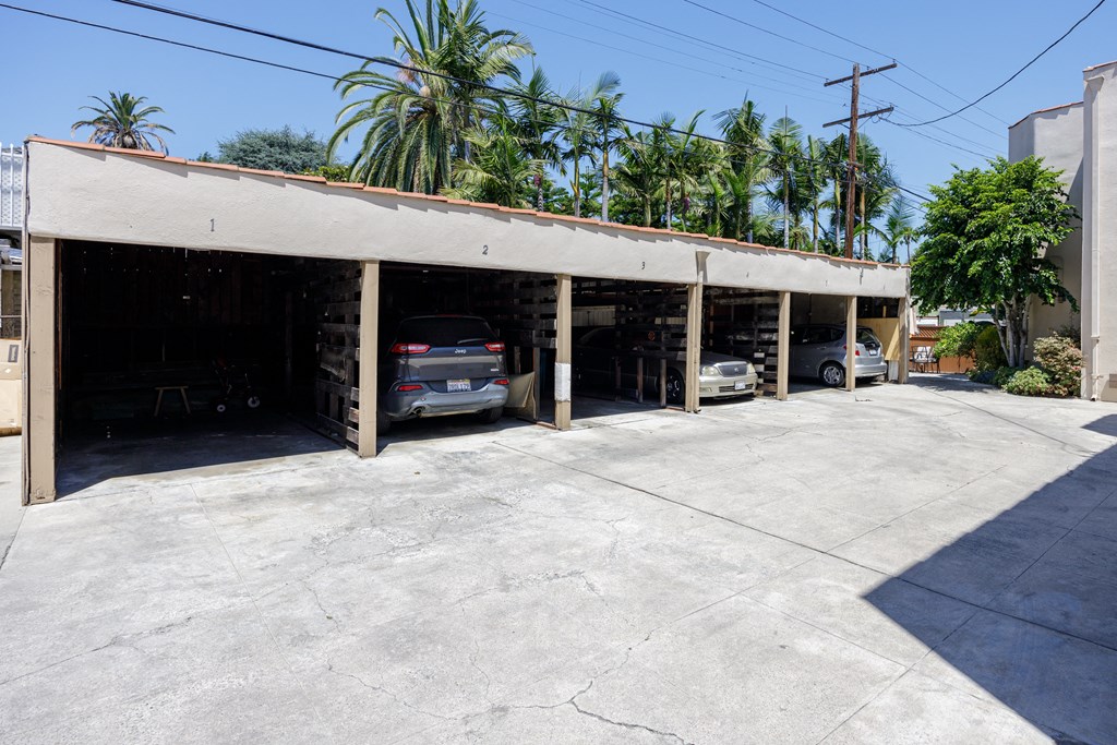 a parking garage with cars in it and palm trees