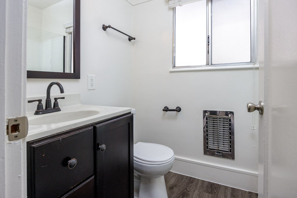 a bathroom with a sink and a toilet and a bath tub