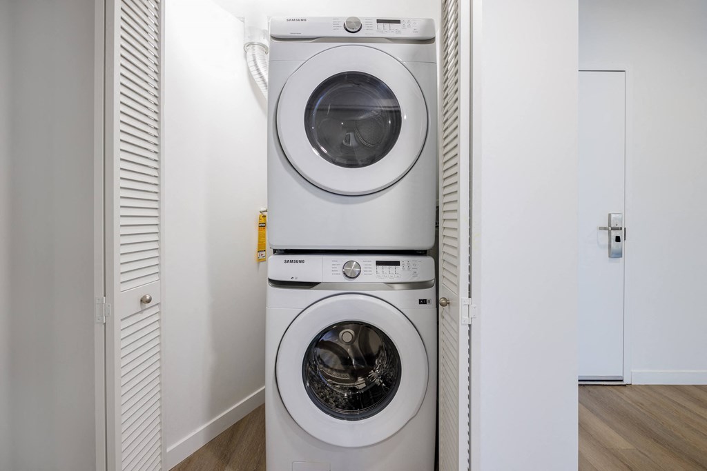 a white washer and dryer in a white laundry room