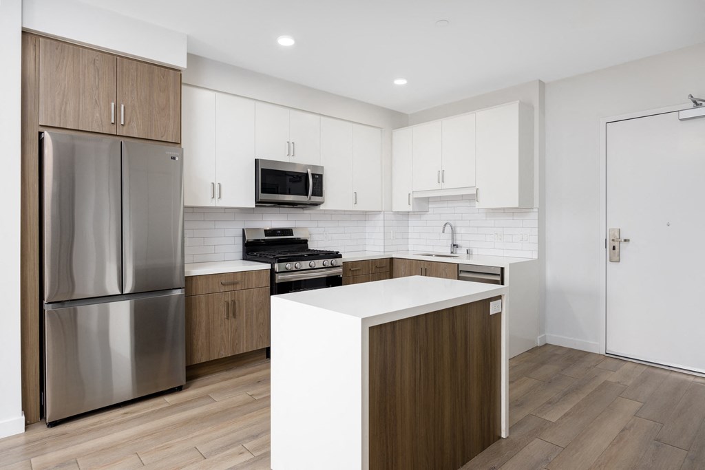 a kitchen with white cabinets and stainless steel appliances